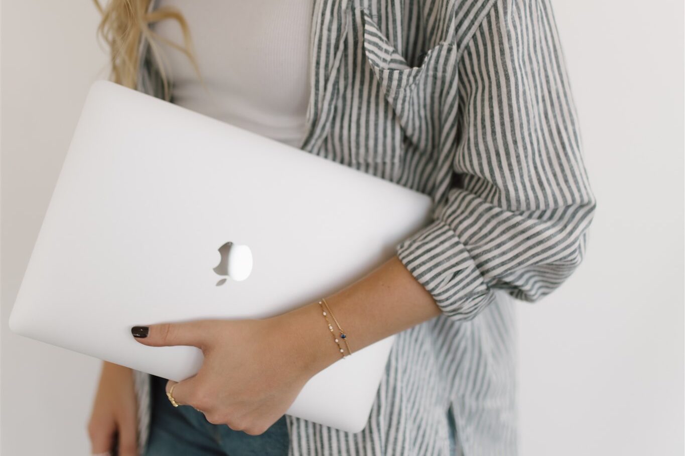 pinterest manager holding laptop while walking