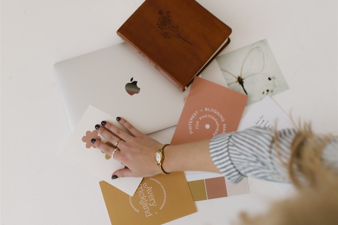 pinterest manager organizing branding flatlay for photoshoot